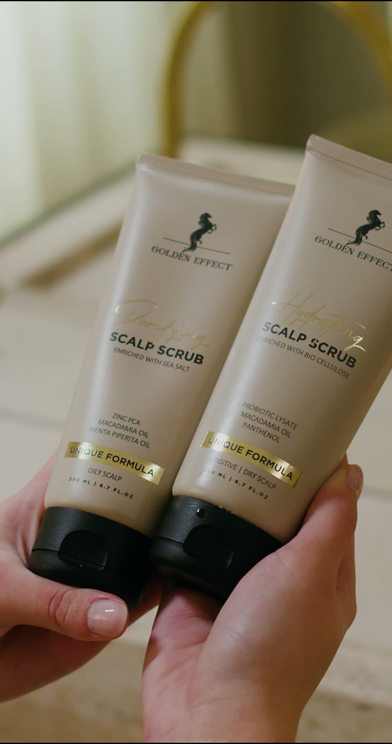 Golden Effect scalp scrub tubes in hand