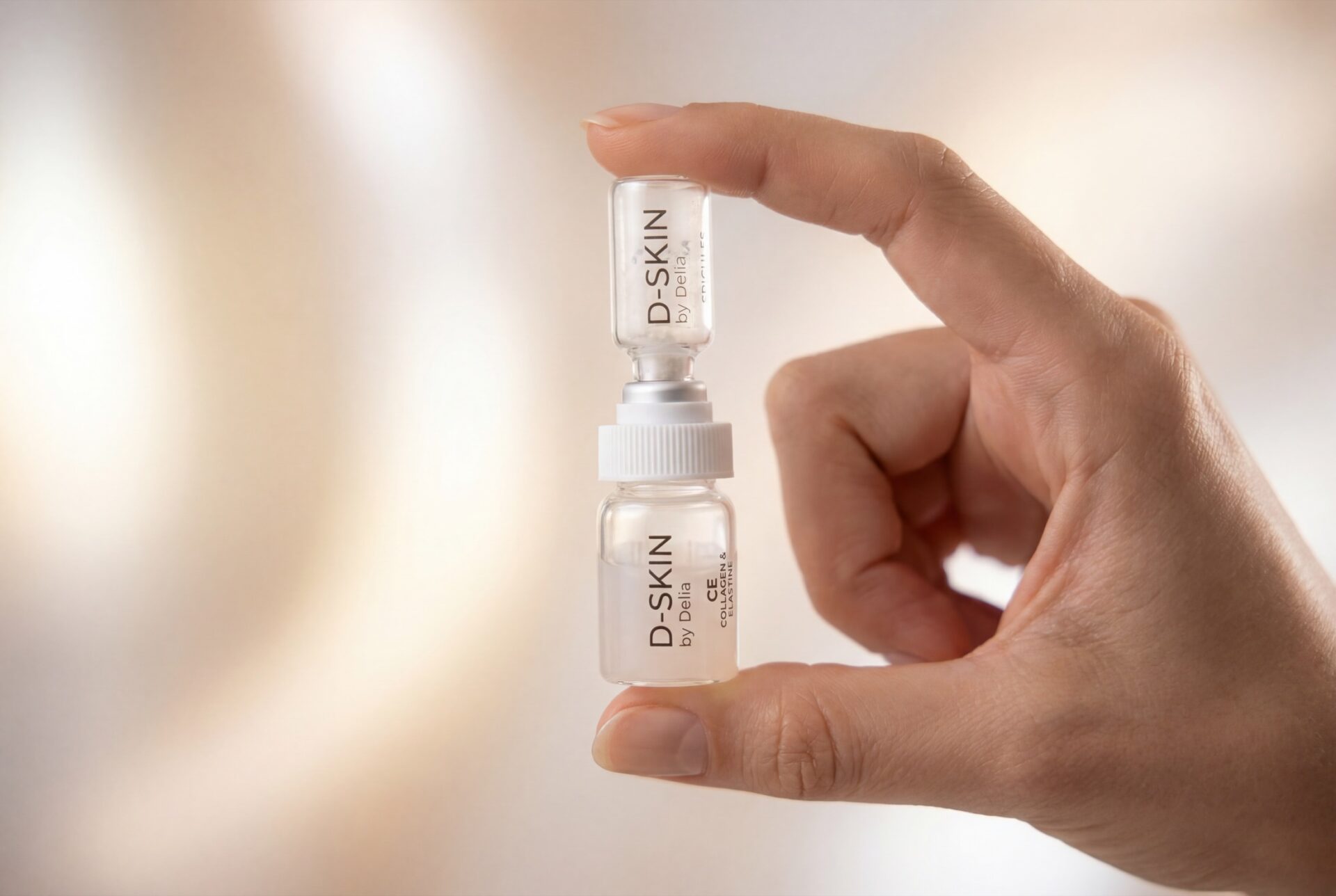 D-SKIN Synergy treatment vial held between fingers