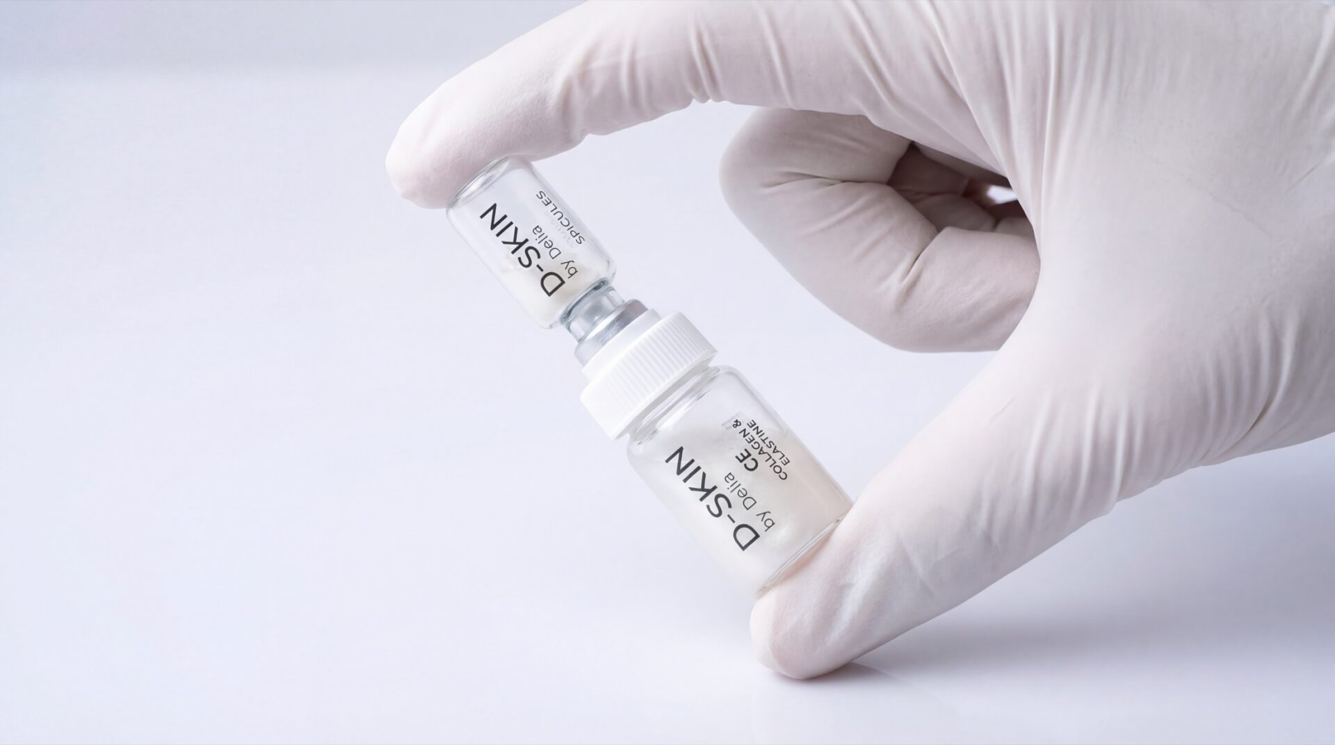 Gloved hand connecting D-SKIN Synergy treatment vials